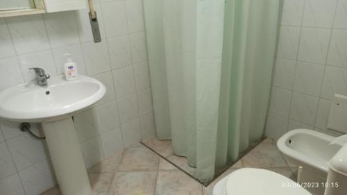 y baño con lavabo, ducha y aseo. en Villa vista mare en Santa Cesarea Terme