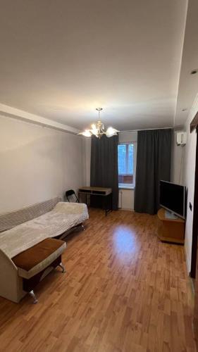 a room with two beds and a flat screen tv at Obolonskiy Prospekt Apartments 16Є in Kyiv