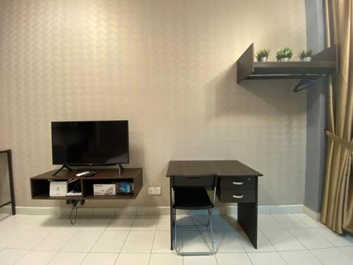 a desk with a television and a desk with a chair at 5mins to Sunway #Subang SS15 Stylish Studio #3pax in Subang Jaya