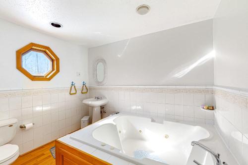 Serenity Now & Ever في Owls Head: حمام أبيض مع حوض ومغسلة