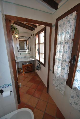 a bathroom with a toilet and a window and a mirror at Appartamento VIAROMA58 - Vicinissimo al mare con clima e posto auto in Marina di Campo