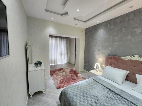 a bedroom with a large bed in a room at Park Azure Best apartment in Baku