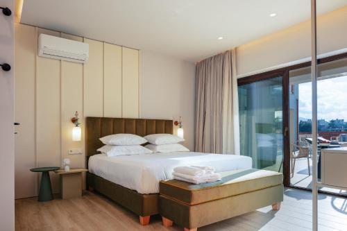 a bedroom with a bed and a balcony at Vellis Residence in Stavromenos