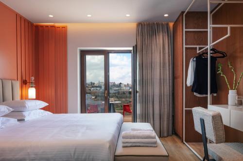 a hotel room with a large bed and a window at Vellis Residence in Stavromenos