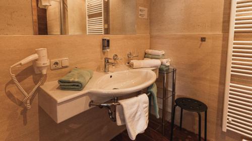 a bathroom with a sink and a mirror at Pension Truya - Hof in Fiss