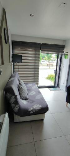 a large bed in a room with a window at Aux Passagers de la baie 2 in Le Crotoy