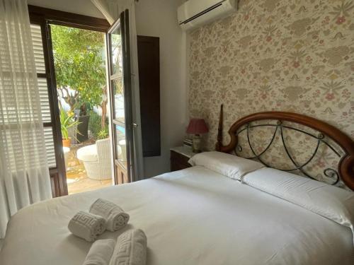 a bedroom with a bed with two towels on it at Suite Comares in Granada