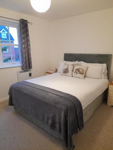 um quarto com uma grande cama branca e uma janela em Glastonbury town center-entire apartment em Glastonbury