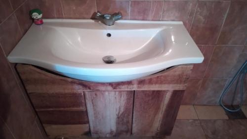 a white sink in a bathroom at Madampa Ganga Villa. in Ambalangoda