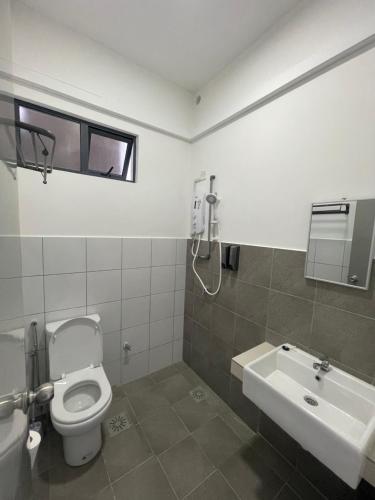 a bathroom with a toilet and a sink at Sandakan Blue Coastal escape 蓝海岩栖 in Sandakan