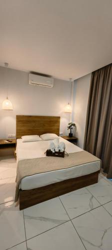 a bedroom with a large bed in a room at TOPAZ two in Siviri