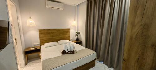 a hotel room with a bed with white sheets at TOPAZ two in Siviri