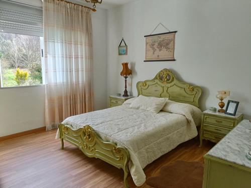 a bedroom with a large bed and a window at Piso Costa da Morte in Ponte Do Porto