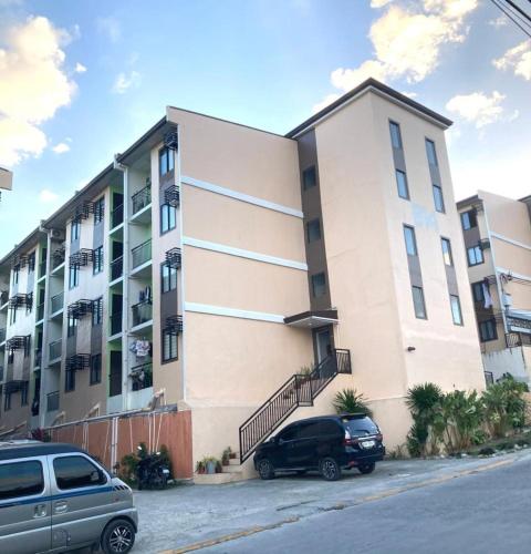 a building with cars parked in front of it at Deca homes condominium tisa Labangon in Cebu City
