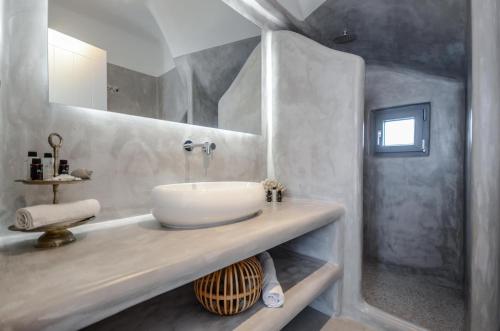 a white bathroom with a sink and a shower at Casa Rakan in Naxos Chora