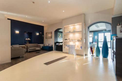 un salon avec un canapé et une table dans l'établissement Best Western Hotel De La Plage Saint Marc sur Mer, à Saint-Nazaire