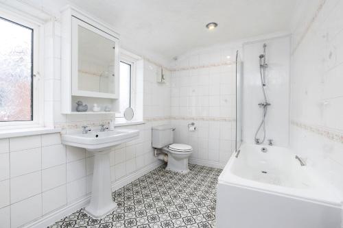 a white bathroom with a sink and a toilet at Bishop's Little Palace in Bishop Auckland