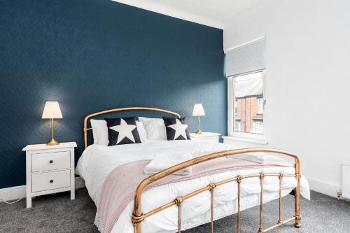 a bedroom with a large bed with a blue wall at Bishop's Little Palace in Bishop Auckland