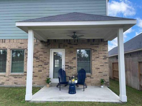 a pavilion with two chairs and a table in front of a house at Spacious and fully equipped family house for 10 in Shenandoah