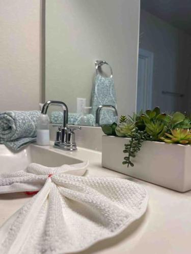 a white towel on a bathroom sink in front of a mirror at Spacious and fully equipped family house for 10 in Shenandoah