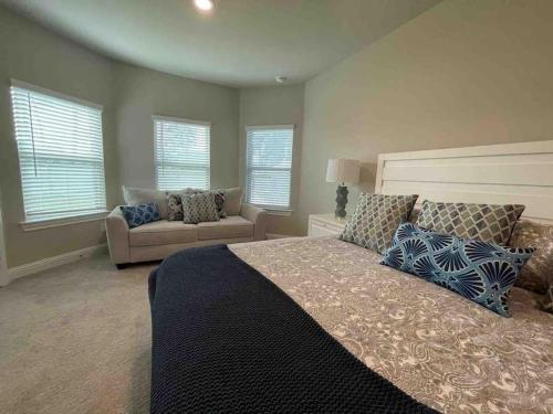 a bedroom with a large bed and a couch at Spacious and fully equipped family house for 10 in Shenandoah