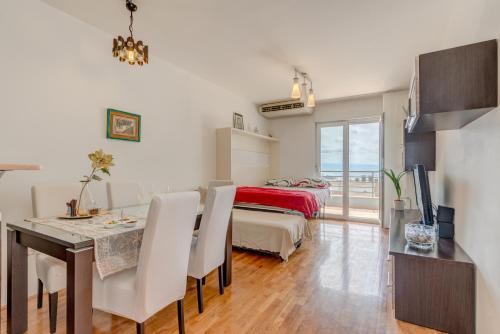 ein Wohnzimmer mit Esstisch und ein Schlafzimmer in der Unterkunft Comfy & Urban apartment on Žnjan near beach in Split