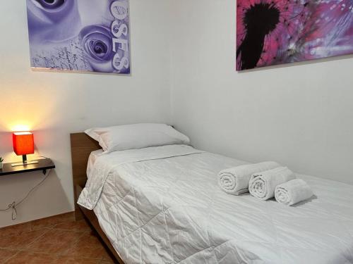 a bedroom with a bed with towels on it at COSENZA Galluppi 23 in Cosenza