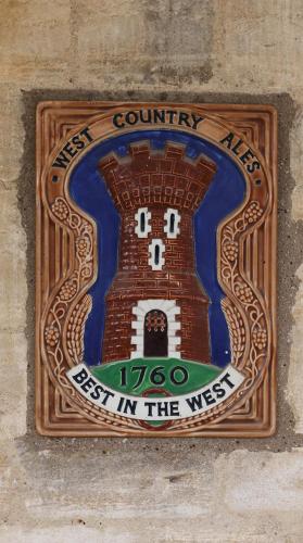 a sign that says best in the west on a wall at A handsome large 9 bedroom 17th Century village house moments from The Cotswold Way offering modern luxury in a peaceful location in Frocester