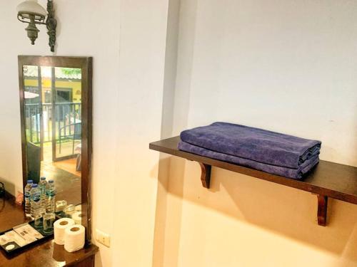 a shelf with a purple pillow on it next to a mirror at beautiful pool house in Patong Beach