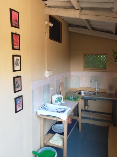 a small kitchen with a table and a sink at Lady Gordons Homestay in Kandy