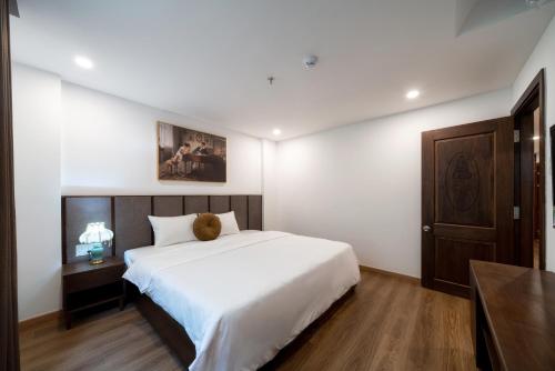 a bedroom with a bed with a teddy bear on it at Langmandi Hotel & Apartment in Da Nang
