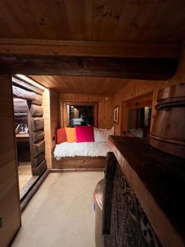 a small room with a bed in a cabin at Cozy 500 Years Old Walser Home in Alagna Valsesia