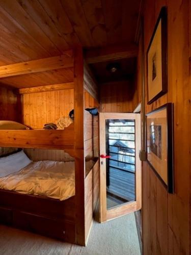 a small room with a bunk bed in a cabin at Cozy 500 Years Old Walser Home in Alagna Valsesia