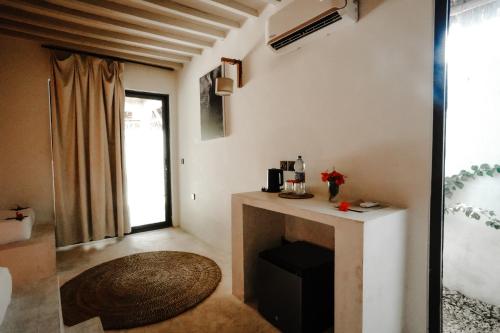 a living room with a table and a window at Seconda Stella Romantic Hideaway in Jambiani