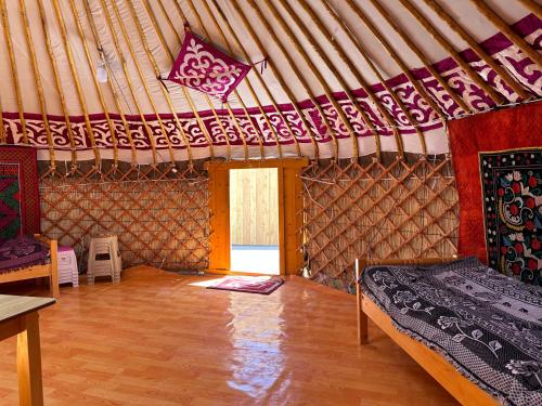 a room with a bed and a window in a yurt at Traditional Yurts - Ulgii Guest House in Ölgiy