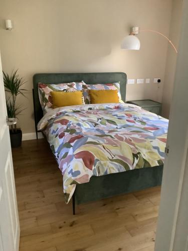 a bed with a colorful comforter in a bedroom at Springwood - Royal Hillsborough in Hillsborough