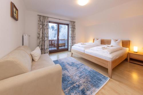 a living room with two beds and a couch at Ferienhaus am See in Zell am See