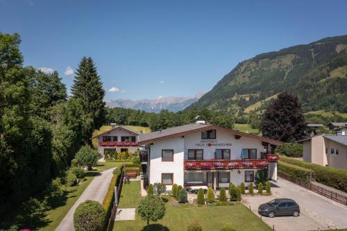 an aerial view of a house with mountains in the background at Ferienhaus am See in Zell am See