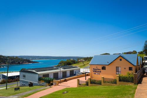a house with a view of the ocean at Snug Cove Villas in Eden