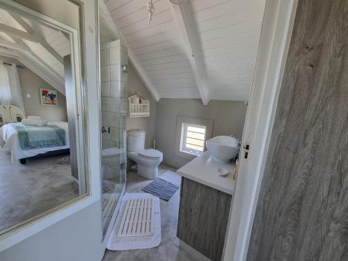a small bathroom with a toilet and a sink at Manatoka Unit 3 in Jacobs Bay