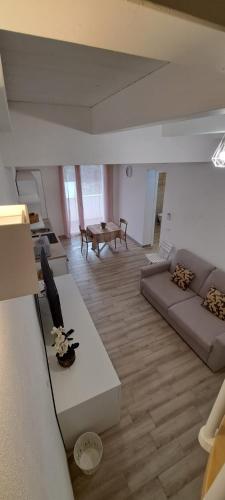 a living room with a couch and a table at SUITE BLANC APARTMENTS - Monolocali indipendenti con cucina e bagno privato - Check-in e check-out con codice in autonomia h24 - Terrazza in comune NECESSARIO AVERE WATHSAPP O APP DI MESSAGGISTICA ISTANTANEA PER FOTO E VIDEO in Guspini