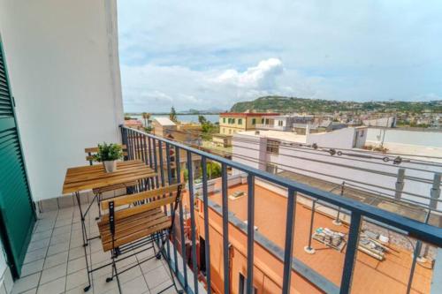 a balcony with benches and a view of the water at Bacoli Sveva Luxury House - Terrace & Design in Bacoli