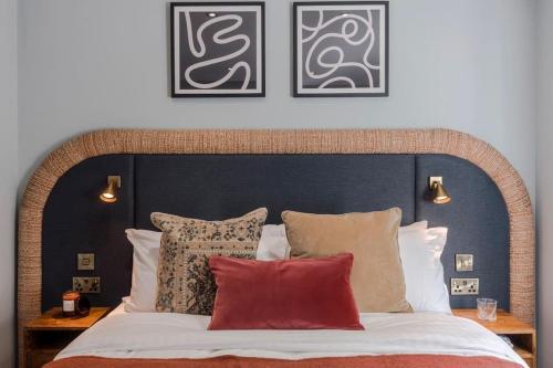 a bedroom with a large bed with pillows at 12 Barley View Luxury Home in Bristol