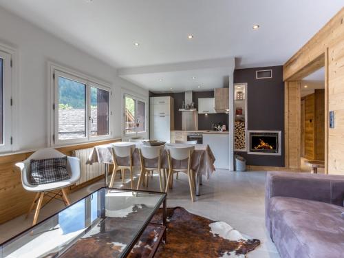 une cuisine et un salon avec un canapé et une table dans l'établissement Chalet cosy au cœur du village, proche pistes et activités, avec cheminée et WIFI - FR-1-304-6, à La Clusaz