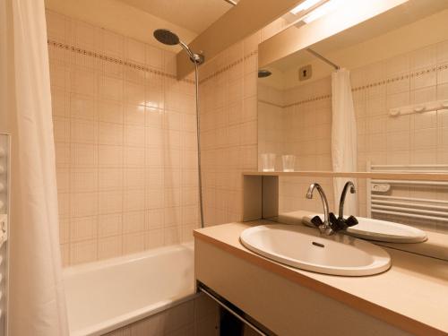 a bathroom with a sink and a bath tub at Studio La Clusaz, 1 pièce, 3 personnes - FR-1-304-264 in La Clusaz