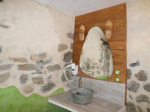 a bathroom with a sink and a mirror at Nuits D'y Cîmes : Nuit Insolite Bulle, SPA in Jaunac