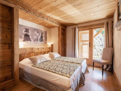 a bedroom with a bed and a window at Appartement La Clusaz, 3 pièces, 4 personnes - FR-1-304-231 in La Clusaz