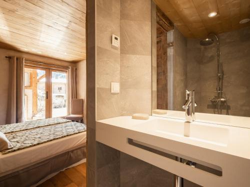 a bathroom with a sink and a bed at Appartement La Clusaz, 3 pièces, 4 personnes - FR-1-304-231 in La Clusaz