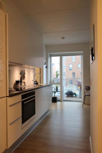 a kitchen with a sink and a stove top oven at Modern apartment in Aarhus with free parking in Risskov