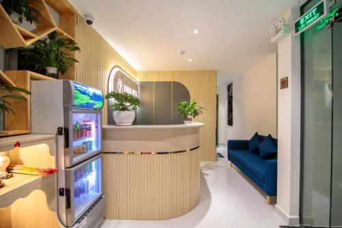 a room with a refrigerator and a blue couch at Bin Bin Hotel 11 Near Island Diamond in Ho Chi Minh City